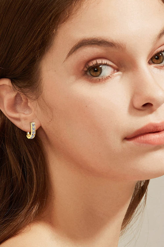 close up of women wearing 1 carat channel set moissanite earrings in platinum and 18K gold-plated 925 sterling silver