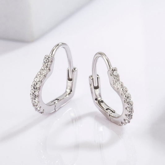 A pair of 925 Sterling silver pavé zircon heart hoop earrings displayed against a white background.