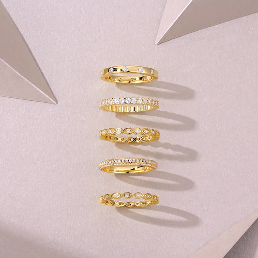 Set of Aurielle moissanite stackable ring set in 18K gold-plated sterling silver layered luxury bands by MerchLuxx on a light gray background