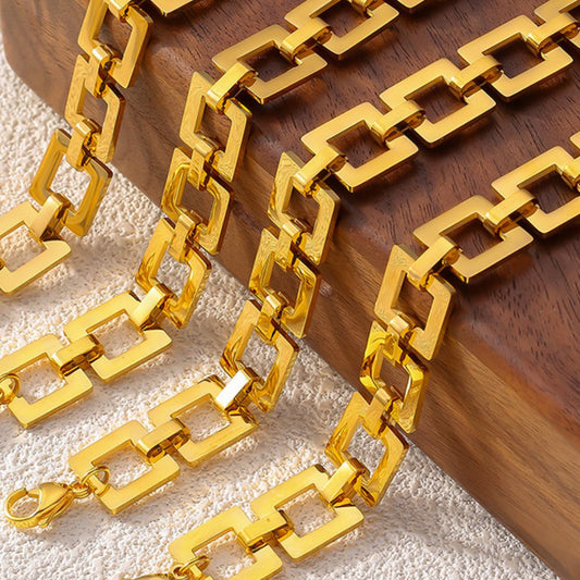 18K gold-plated titanium steel hollow square link bracelet displayed on a wooden box