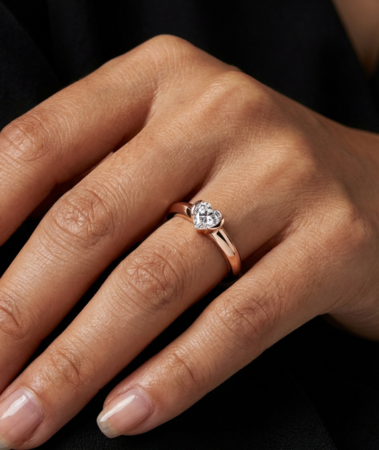 heart-shaped 0.5 carat moissanite solitaire ring in 18k rose gold plated sterling silver
close-up of rose gold heart cut moissanite ring on hand