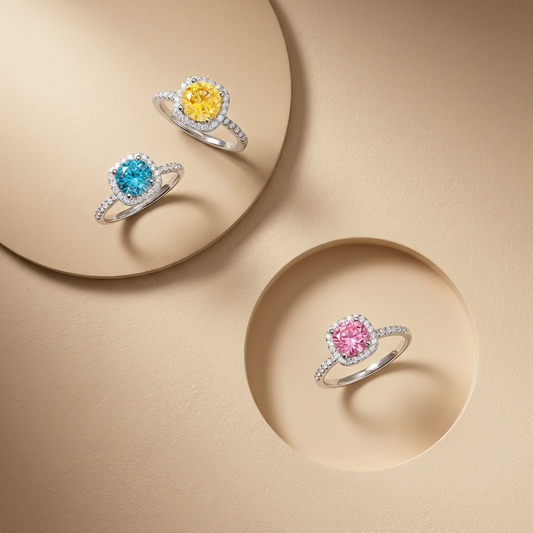 Adorea 1-carat moissanite halo ring in sterling silver by MerchLuxx with a central blue, gold or pink moissanite surrounded by smaller clear stones on a beige background
