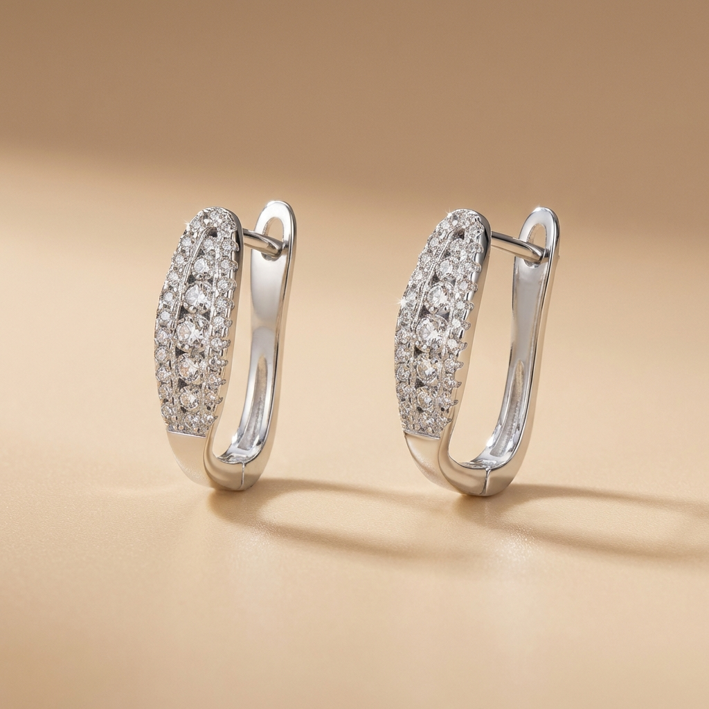 Pair of Pavé moissanite hoop earrings in rhodium-plated sterling silver by MerchLuxx on a beige background