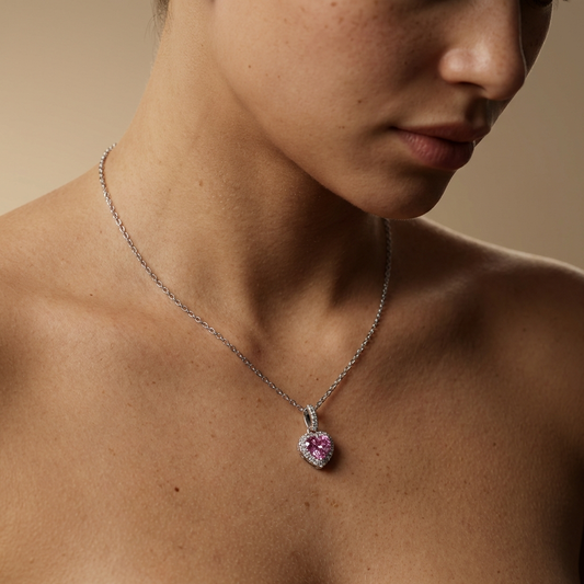Close up of a women wearing a 1 carat pink heart moissanite pendant necklace in platinum-plated 925 sterling silver with zircon halo