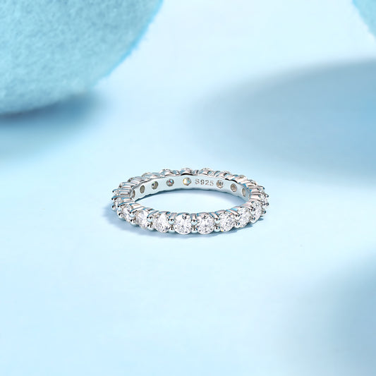 Eternaé moissanite full eternity band in S925 sterling silver continuous round stone ring by MerchLuxx on a light blue background