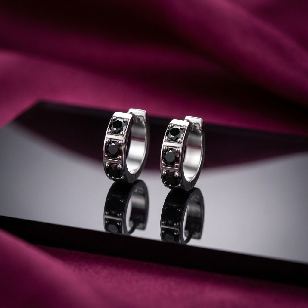 Platinum-plated sterling silver huggie earrings with inlaid moissanite stones in minimalist hoop design