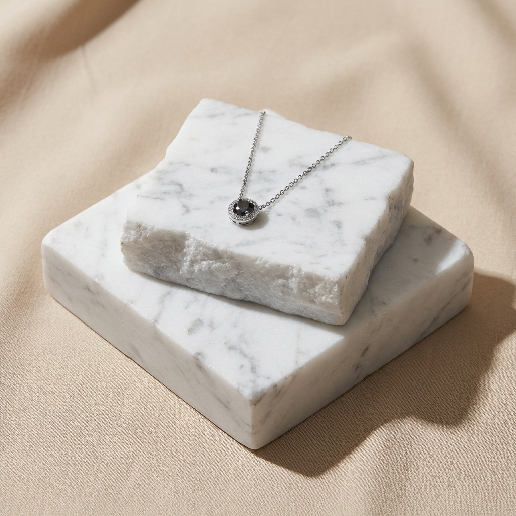 Noctéra 1 carat two-tone moissanite halo pendant necklace in platinum-plated sterling silver by MerchLuxx  on a marble stand against a beige background