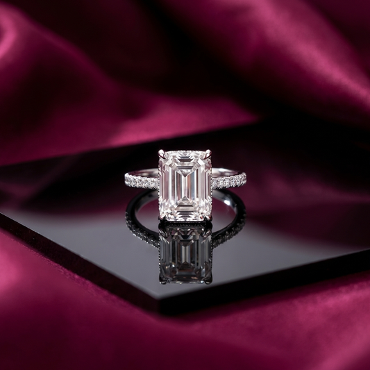 Luminara 9x11mm octagonal moissanite engagement ring in platinum-plated sterling silver cathedral setting by MerchLuxx on a reflective surface with a purple fabric background