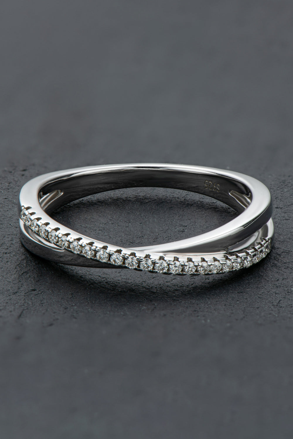 Close-up of polished infinity ring with genuine moissanite