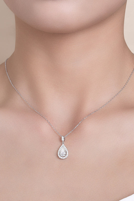 Women wearing 1.5 carat moissanite teardrop pendant necklace in platinum-plated sterling silver with halo zircon accents worn on neckline