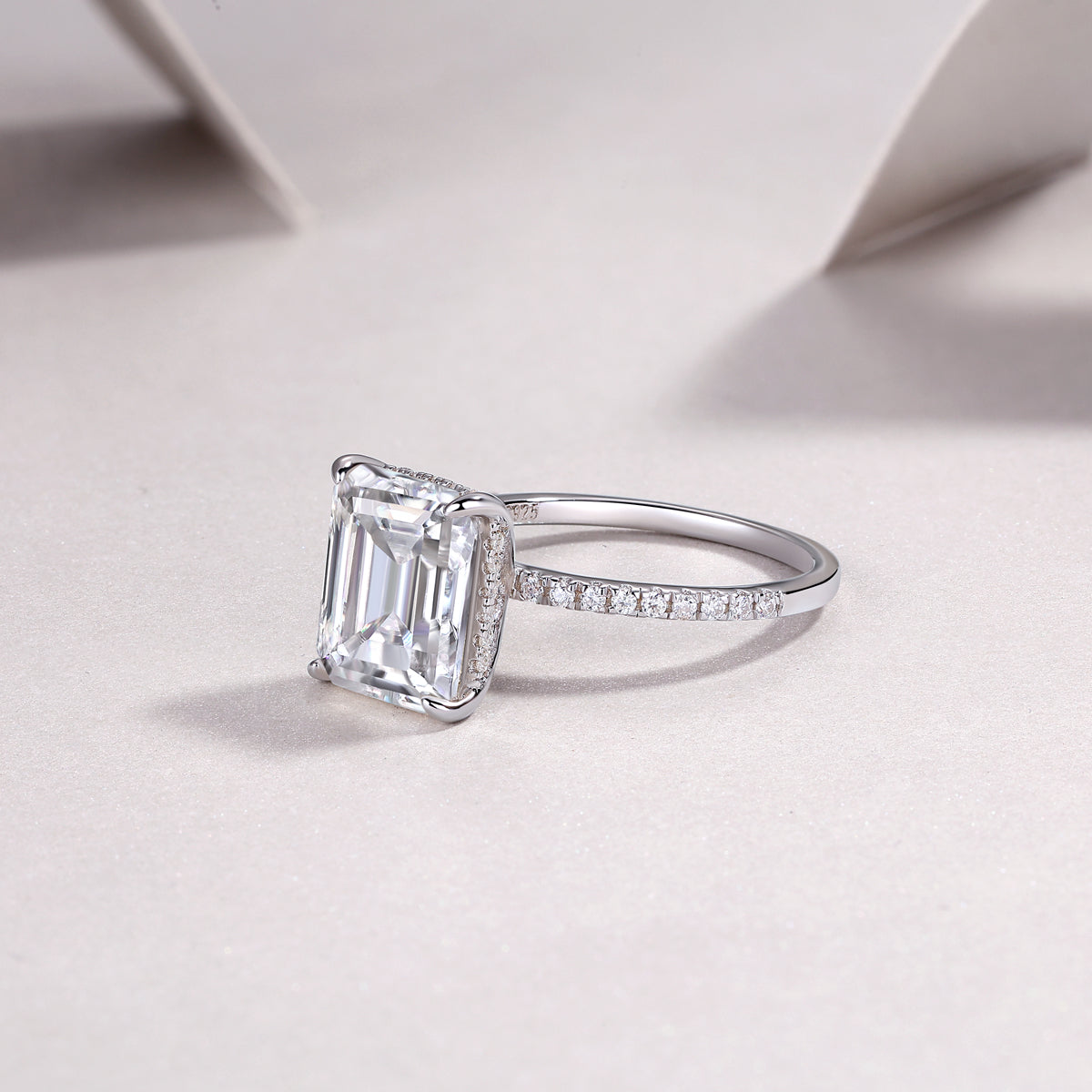 Luminara 9x11mm octagonal moissanite engagement ring in platinum-plated sterling silver cathedral setting by Merchluxx on a light background