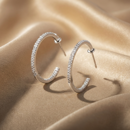 925 sterling silver pavé zircon C-hoop earrings with full sparkle setting on a beige fabric background