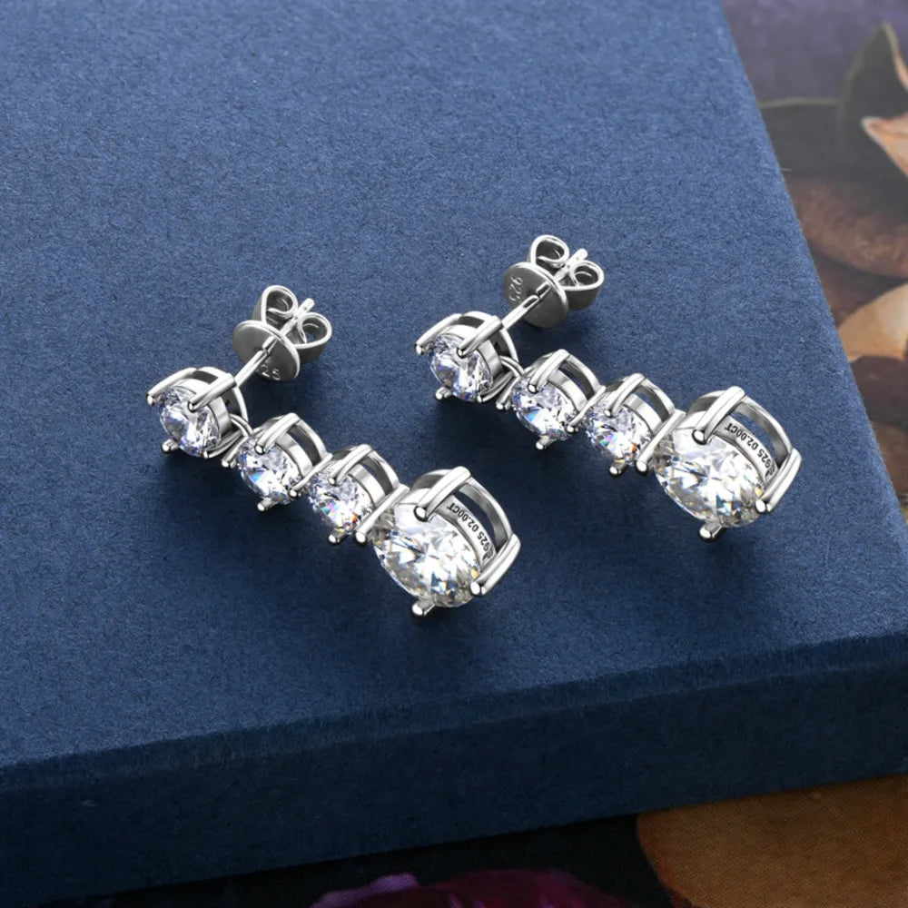 Celestia™ Moissanite Drop Earrings displayed on blue stan