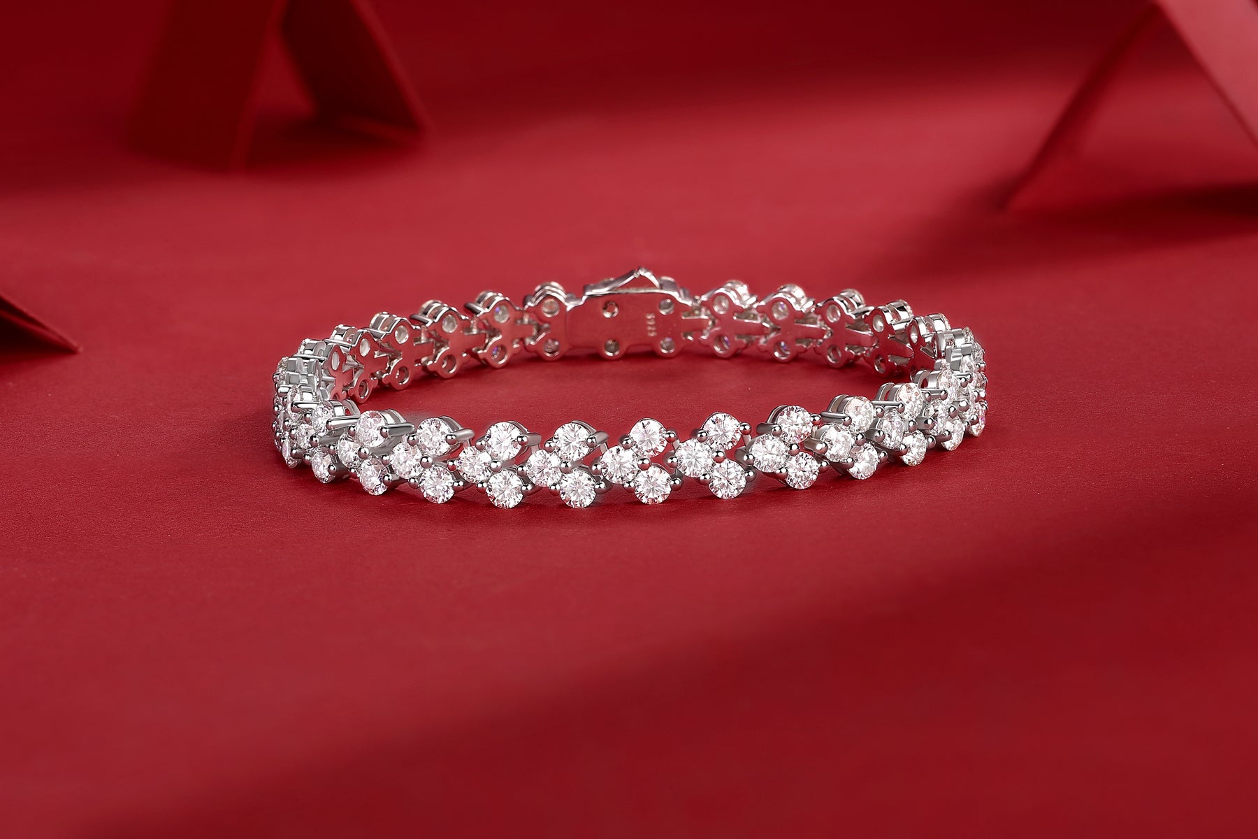 Luminara moissanite cluster tennis bracelet in S925 sterling silver luxury wrist jewelry by MerchLuxx on a red background