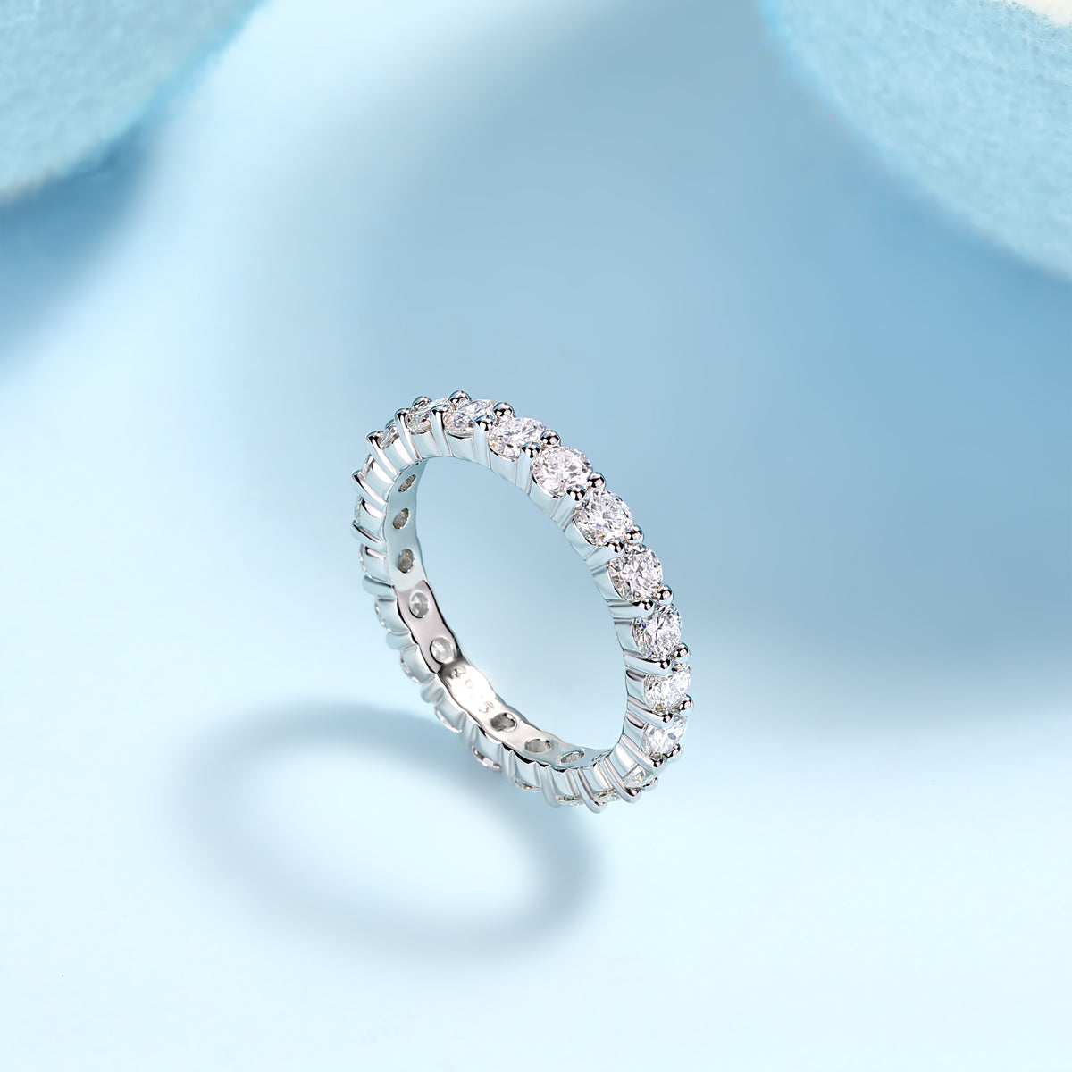 Eternaé moissanite full eternity band in S925 sterling silver continuous round stone ring by MerchLuxx on a light blue background