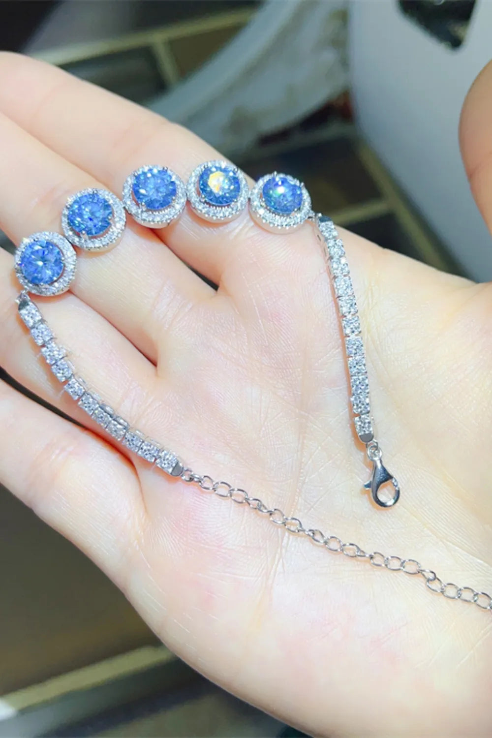 5 carat moissanite tennis bracelet in platinum plated sterling silver worn on wrist