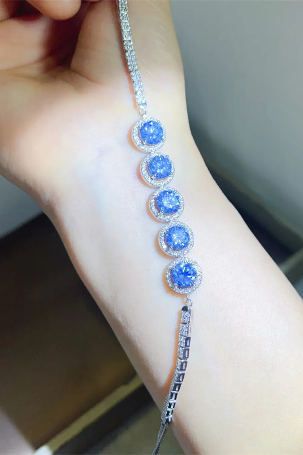 5 carat moissanite tennis bracelet in platinum plated sterling silver worn on wrist