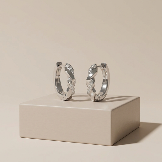 Platinum-plated sterling silver twisted channel set moissanite hoop earrings by MerchLuxx