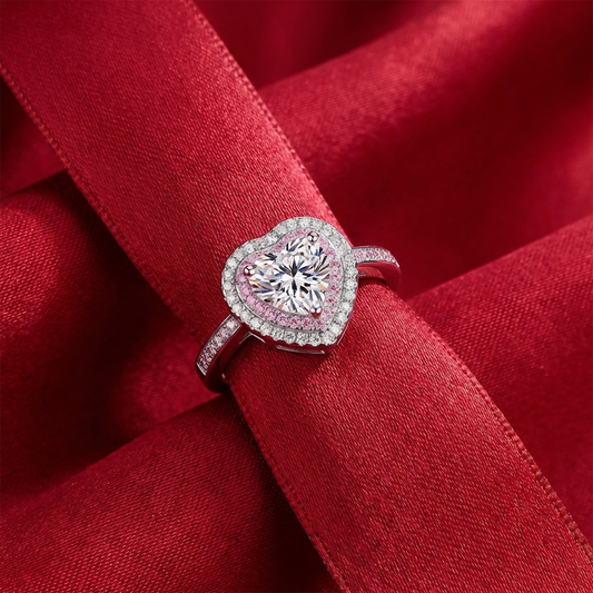 1 carat heart moissanite halo ring in rhodium-plated 925 sterling silver with pavé accents on red fabric