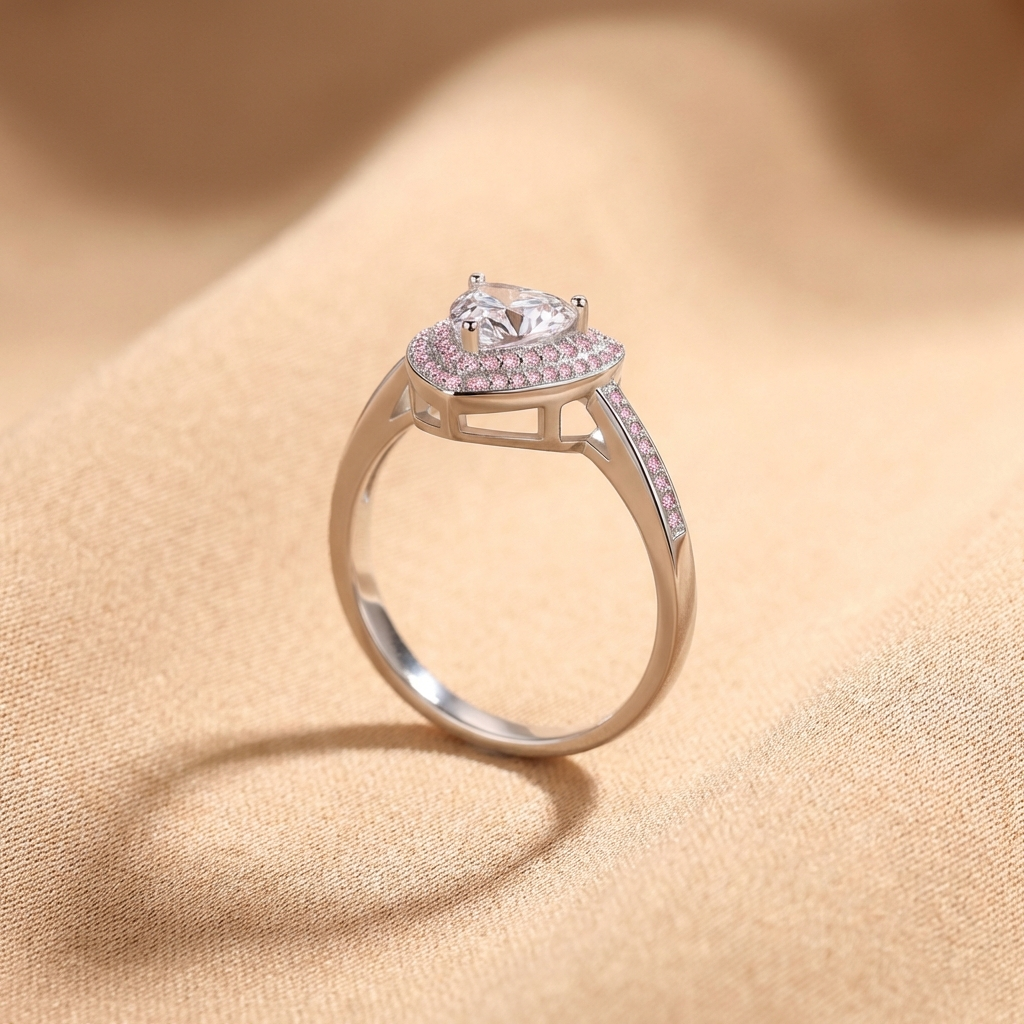 1 carat heart moissanite halo ring in rhodium-plated 925 sterling silver with pavé accents on a beige fabric background