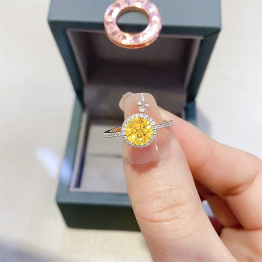 A open box image of the Aurélion yellow moissanite halo ring platinum plated sterling silver MerchLuxx