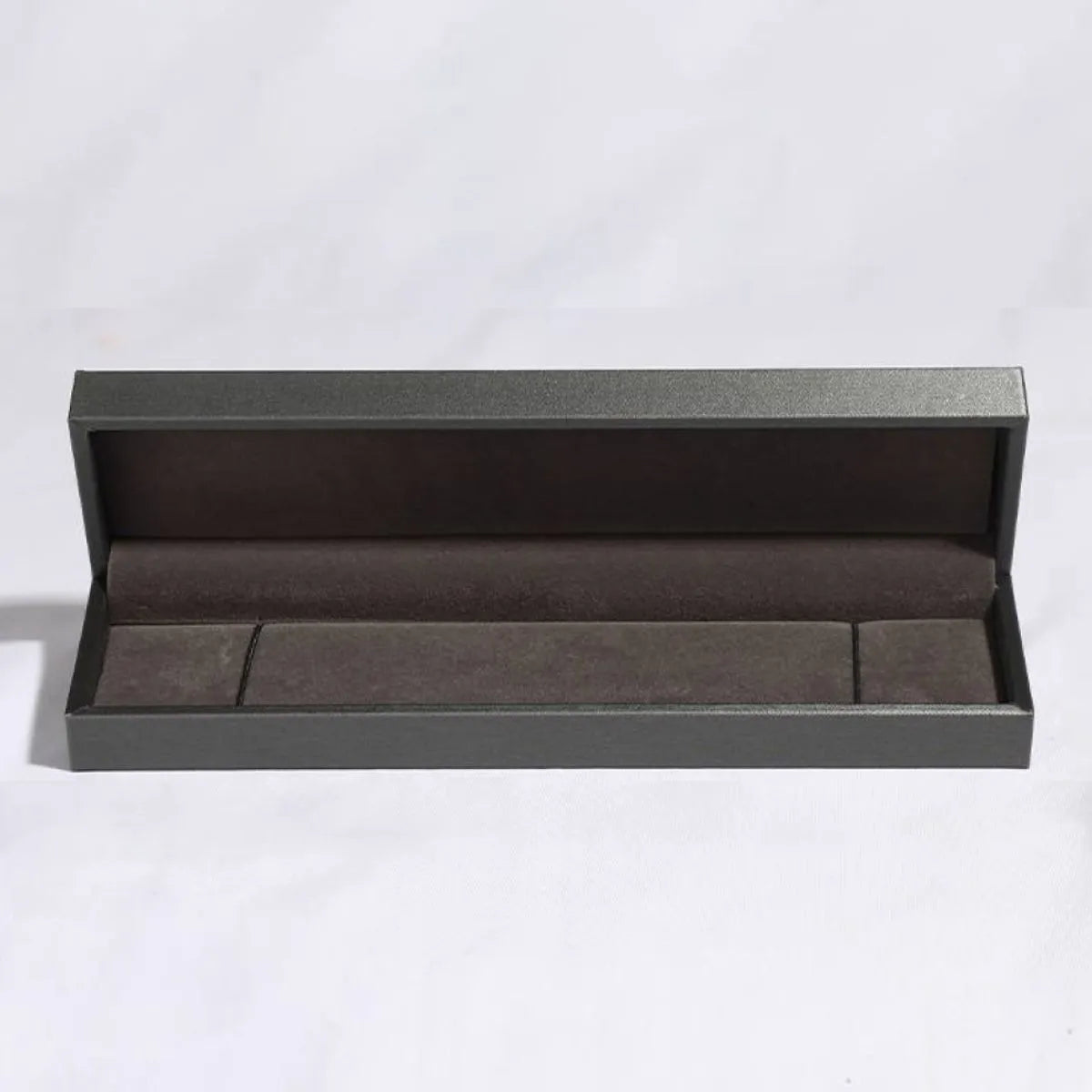 Open gray jewelry box for the 5 carat multicolor moissanite bracelet in sterling silver on a white background