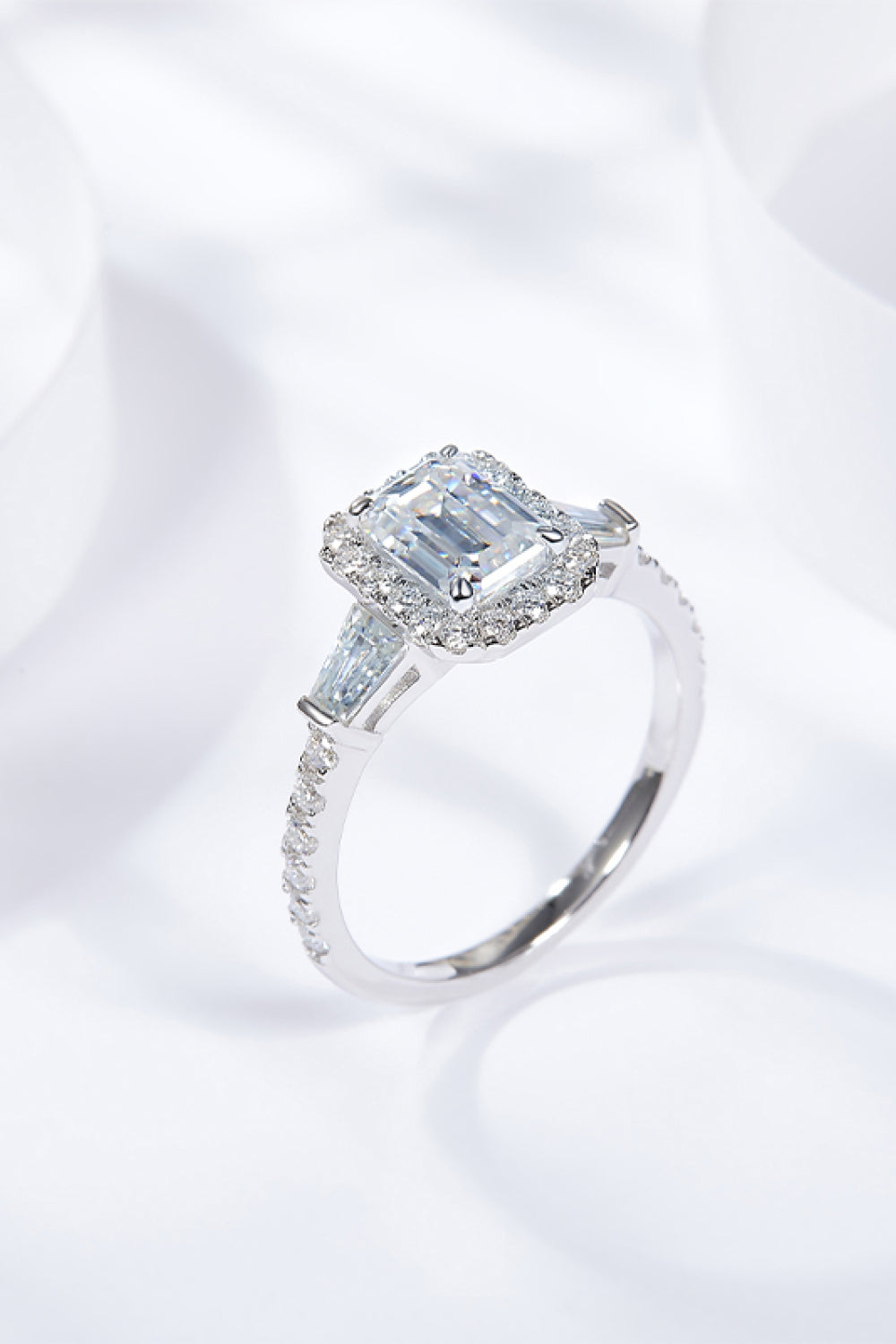 Virella emerald-cut moissanite halo ring in platinum-plated sterling silver by MerchLuxx