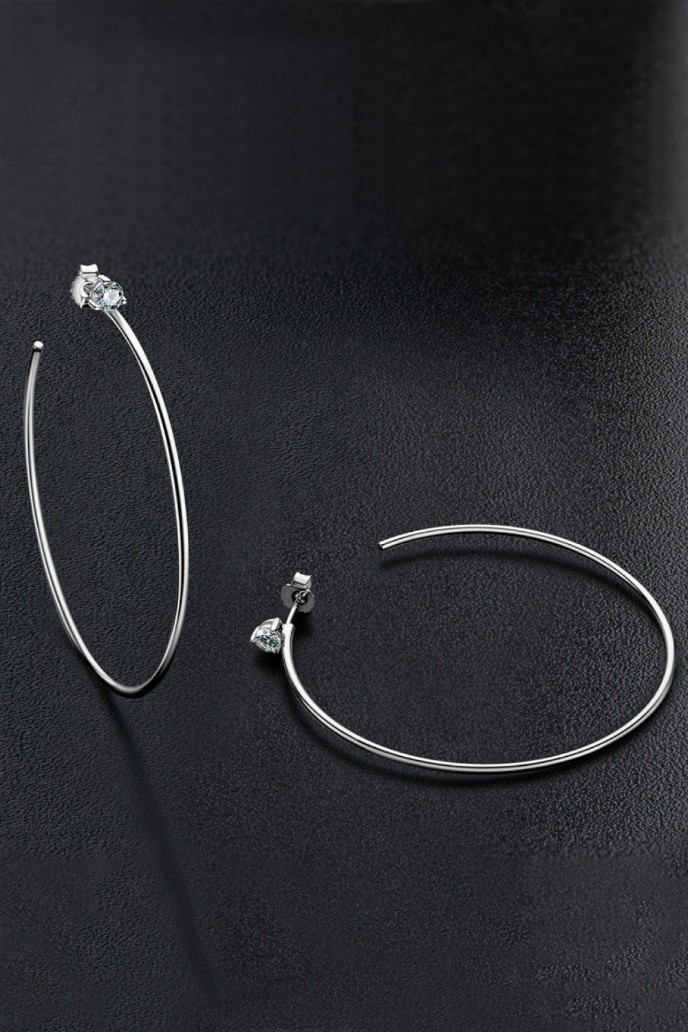 Adoréa platinum plated sterling silver moissanite hoop earrings on black background