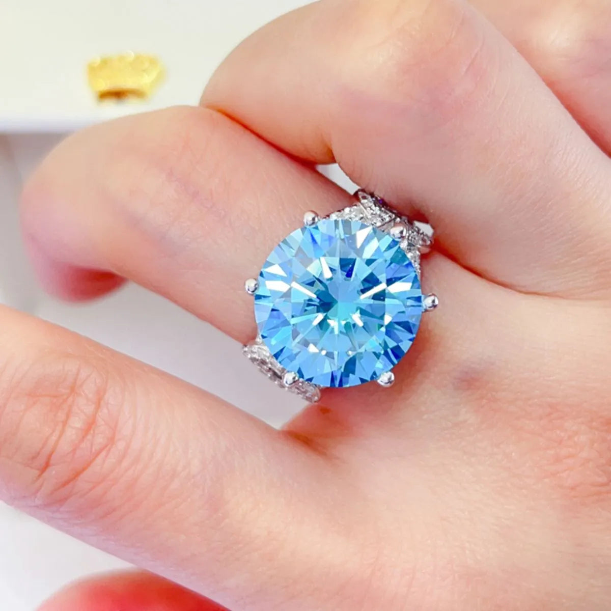 10-carat blue moissanite ring worn on a finger showing stone size