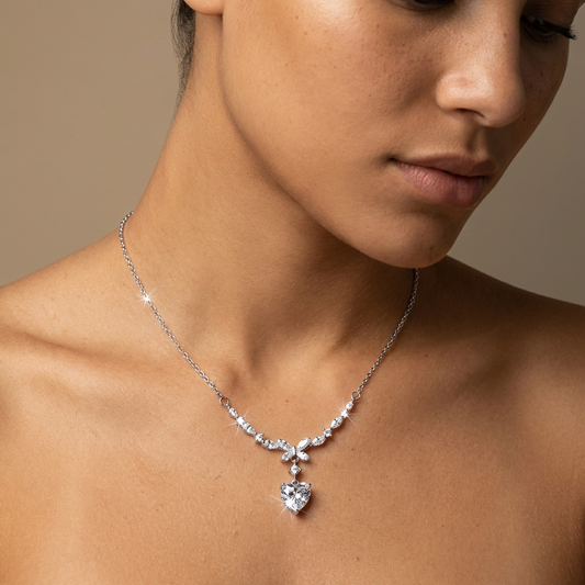 Close up of a women wearing 1 carat heart moissanite vine necklace in platinum-plated 925 sterling silver with marquise accent stones