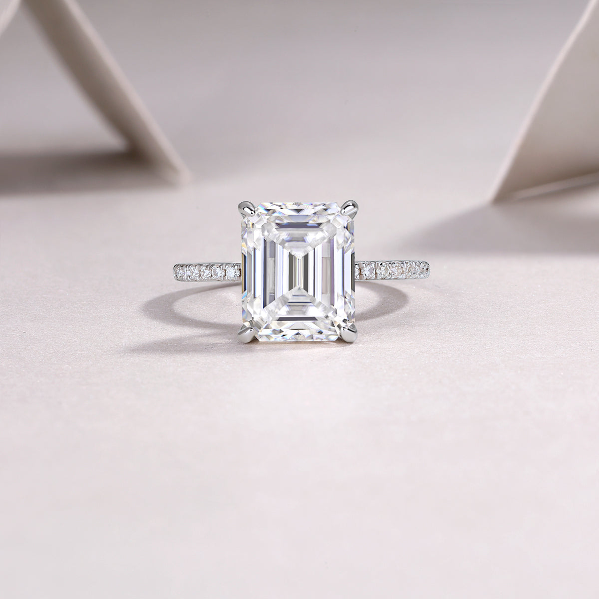 Luminara 9x11mm octagonal moissanite engagement ring in platinum-plated sterling silver cathedral setting by Merchluxx on a light background