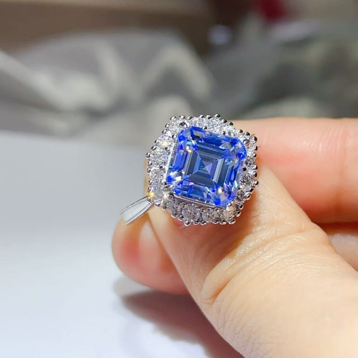 Front close-up of the Sapphire™ Blue Halo Ring highlighting the radiant-cut blue moissanite and double halo