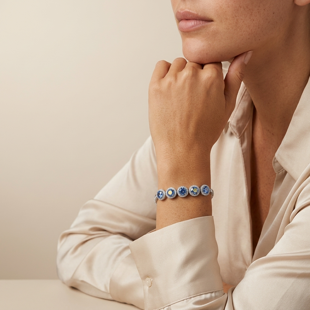 Close-up of a person wearing a 5-carat moissanite tennis bracelet in platinum-plated sterling silver worn on the wrist on a neutral background