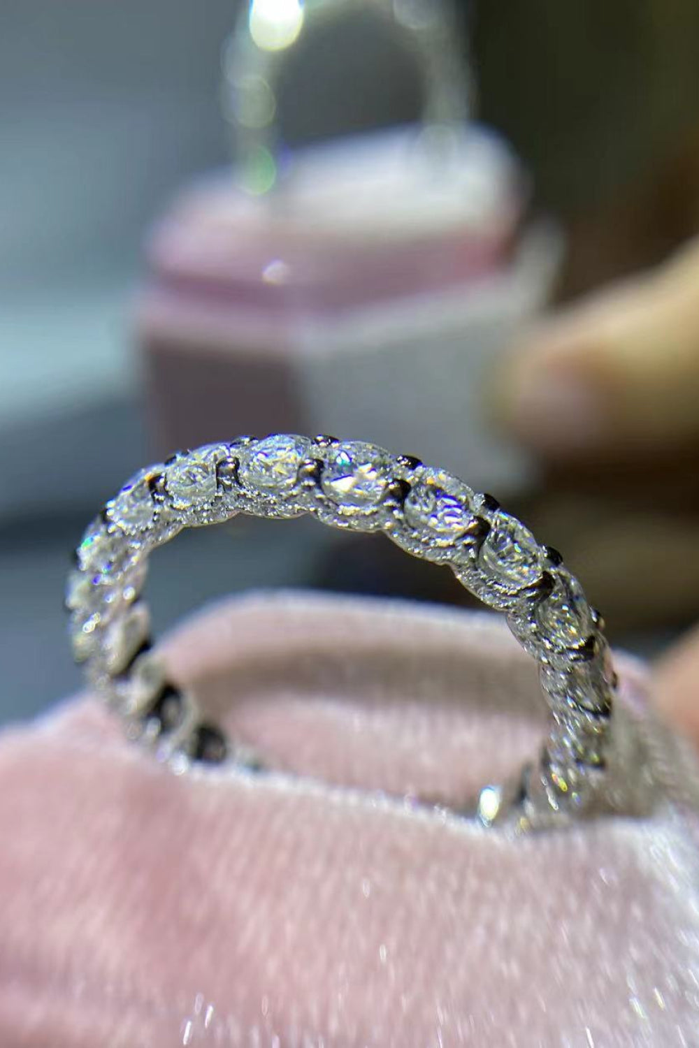 Angled view of the Eternyx™ Moissanite Eternity Ring highlighting the continuous moissanite setting