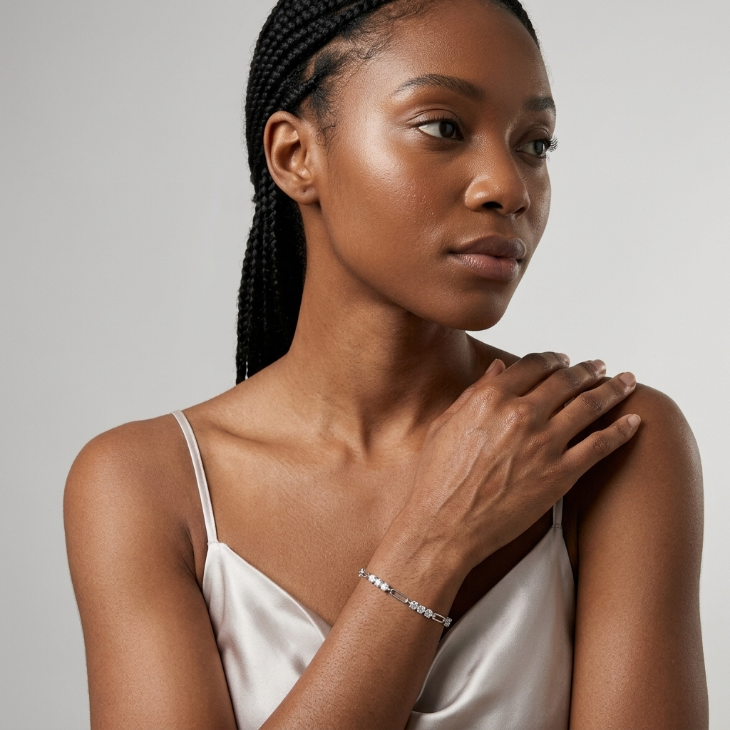 Woman wearing a 1.8 carat minimalist moissanite bracelet in sterling silver on a  a gray background