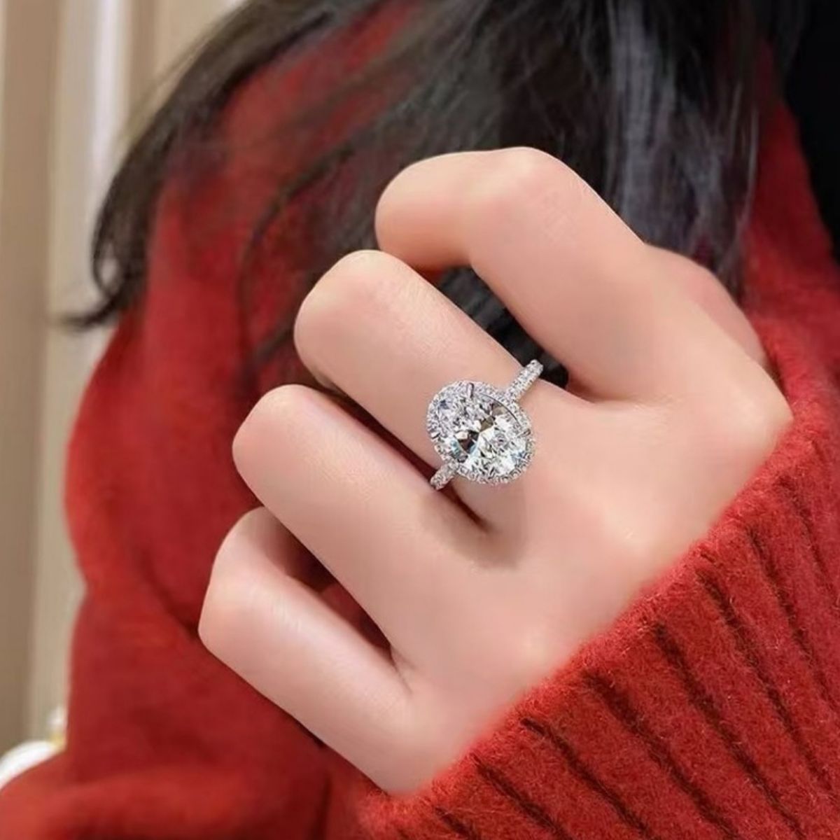 2 carat oval moissanite sterling silver ring worn on finger