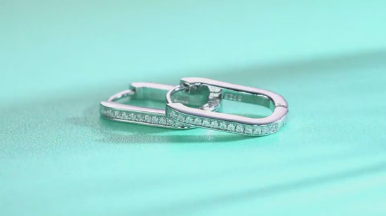 a video for the Avelisse pavé moissanite elongated huggie hoop earrings in platinum-plated sterling silver by MerchLuxx 