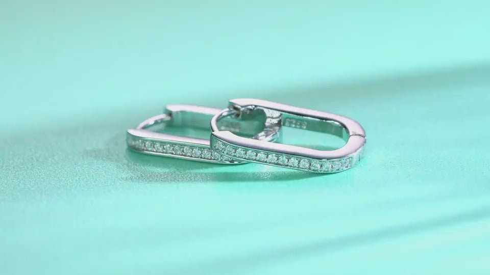 a video for the Avelisse pavé moissanite elongated huggie hoop earrings in platinum-plated sterling silver by MerchLuxx 