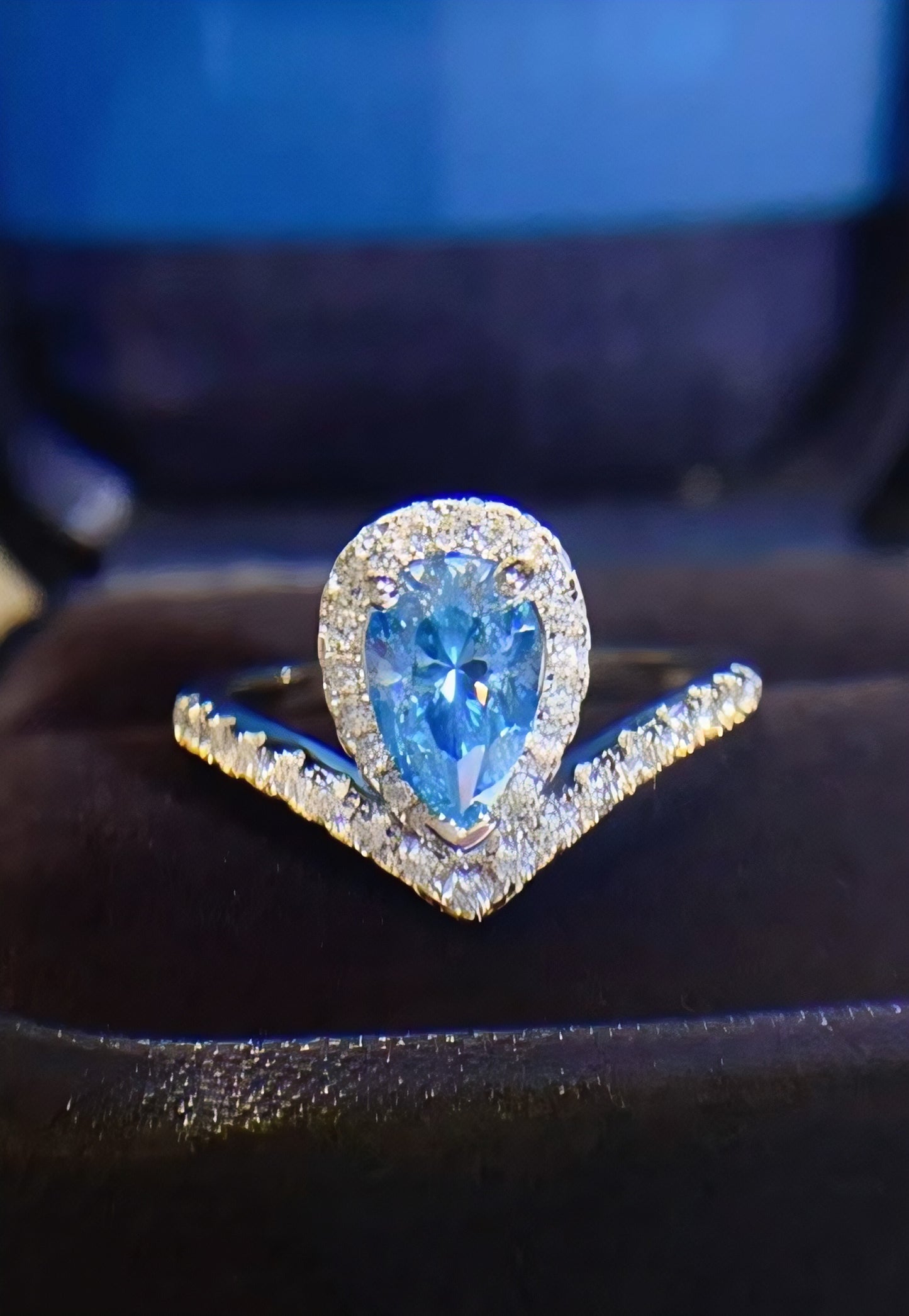 Amouria 1-carat pear-shaped moissanite heart halo ring in platinum-plated sterling silver by MerchLuxx on a dark surface